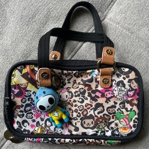 TOKIDOKI beige clutch/purse in cheetah print with rainbow outer zippers.